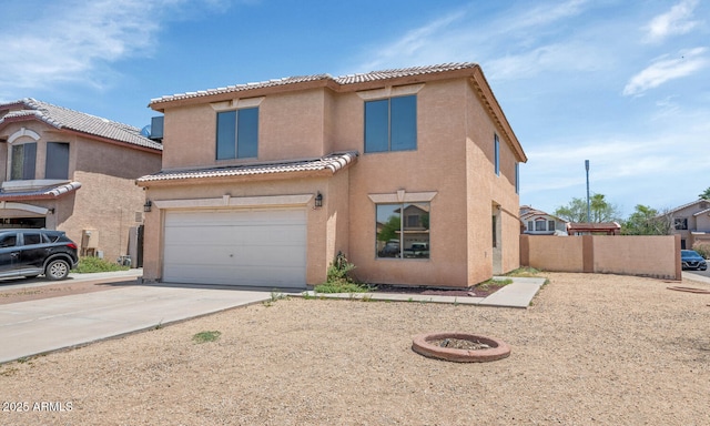 view of front of property featuring stucco siding, driveway, a tiled roof, and an attached garage