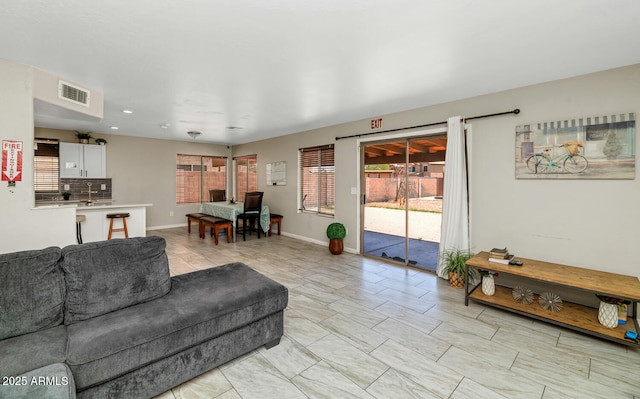 living area with baseboards and recessed lighting
