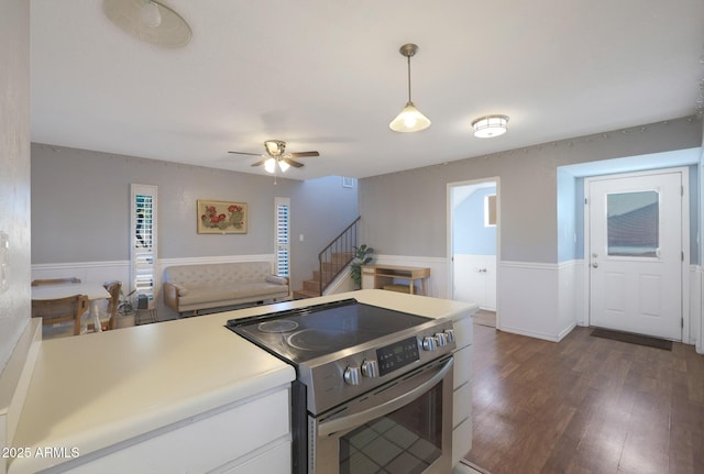 kitchen with white cabinets, electric stove, dark hardwood / wood-style floors, ceiling fan, and decorative light fixtures