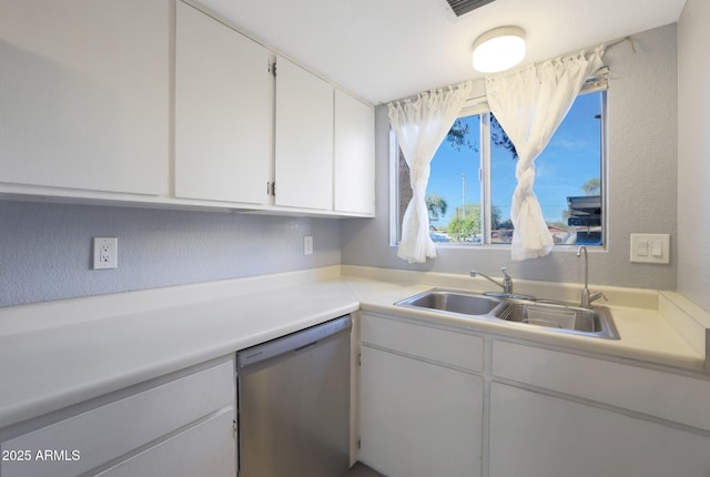 kitchen featuring dishwasher, white cabinetry, and sink