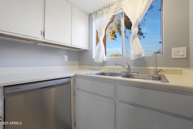 kitchen with white cabinets, dishwasher, and sink