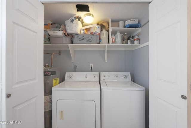 washroom with washing machine and dryer and water heater