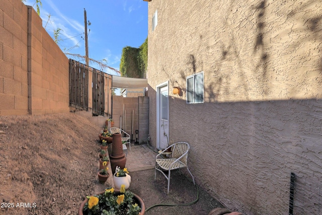 view of side of home with a patio area