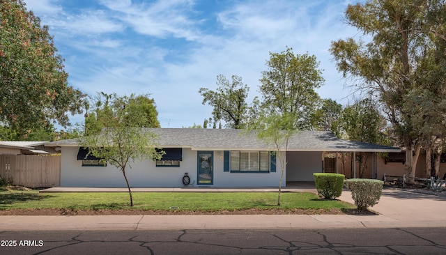 single story home with a front yard, driveway, and fence