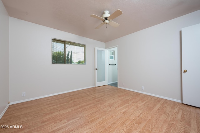 empty room with light wood-style flooring, baseboards, and ceiling fan