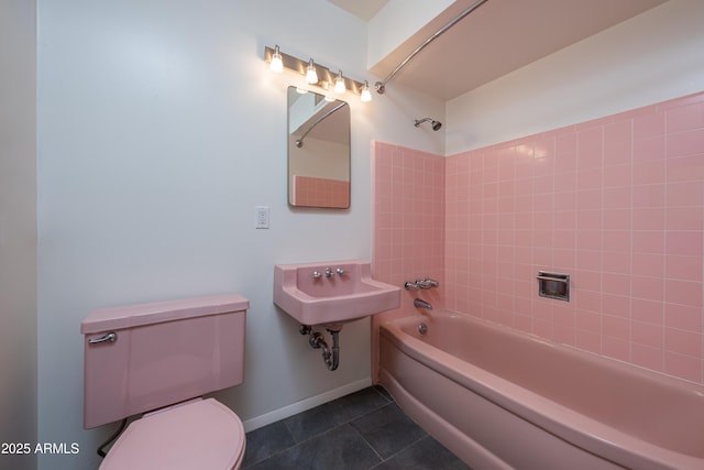 bathroom featuring baseboards, shower / bathing tub combination, toilet, and tile patterned floors