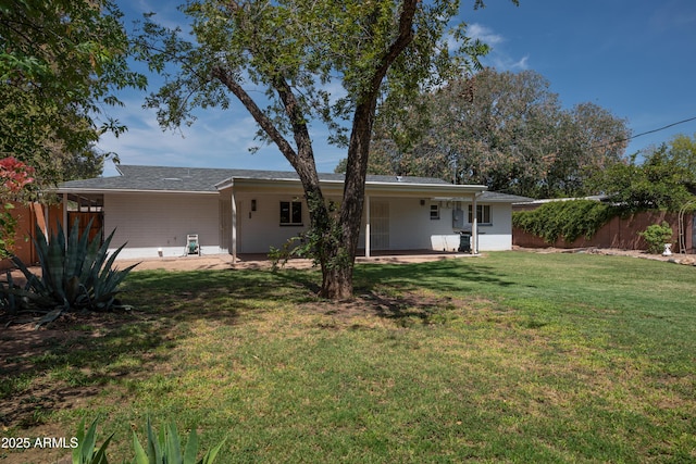 back of house featuring a yard, a patio, and fence