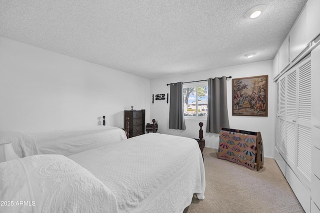 carpeted bedroom featuring a textured ceiling and a closet