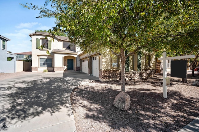 view of property hidden behind natural elements featuring a garage