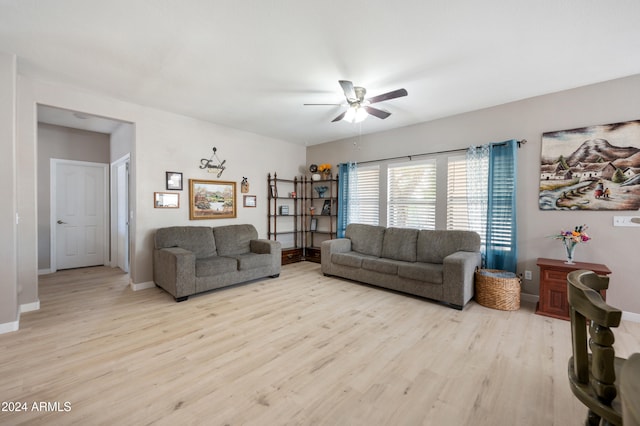 living room with ceiling fan and light hardwood / wood-style flooring