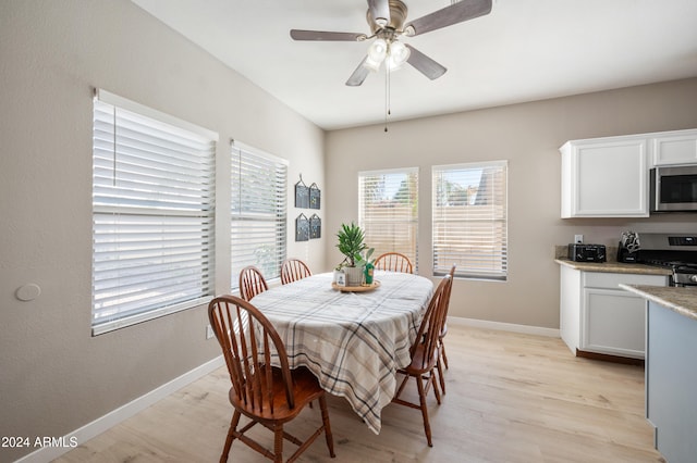 dining room with light wood-type flooring and ceiling fan