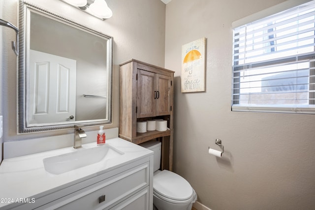 bathroom featuring toilet and vanity