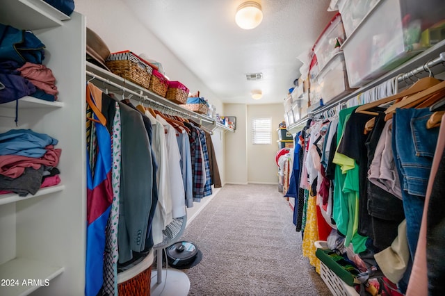 walk in closet featuring carpet