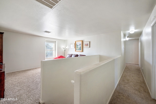 hall featuring light colored carpet