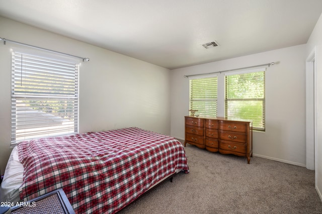 bedroom with light colored carpet