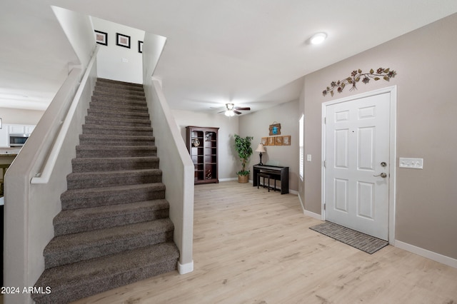 entryway with ceiling fan and light hardwood / wood-style flooring