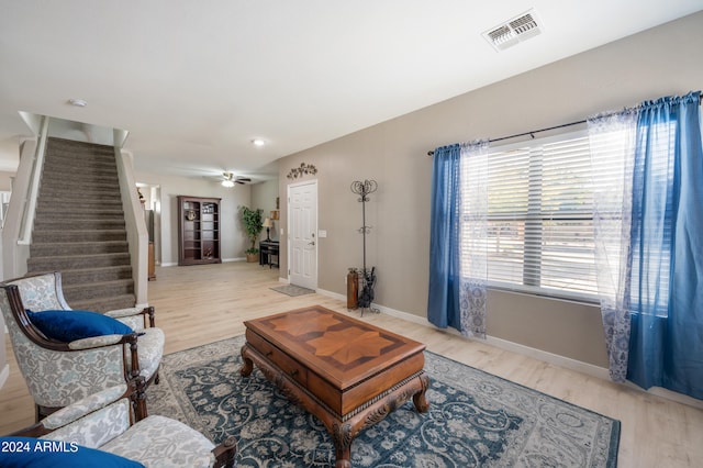 living room featuring ceiling fan and wood-type flooring