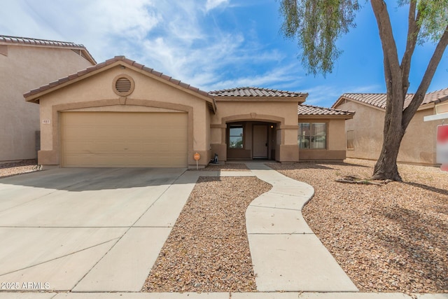 681 W Racine Loop, Casa Grande, AZ 85122 - mediterranean / spanish house featuring concrete driveway, an attached garage, stucco siding, and a tiled roof