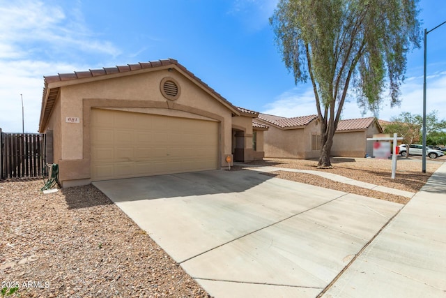 681 W Racine Loop, Casa Grande, AZ 85122 - view of front of property featuring an attached garage, stucco siding, driveway, and a tile roof