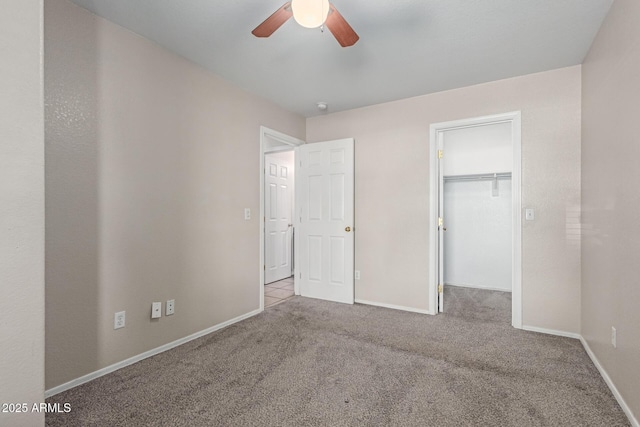 681 W Racine Loop, Casa Grande, AZ 85122 - unfurnished bedroom featuring carpet flooring, baseboards, a spacious closet, a ceiling fan, and a closet