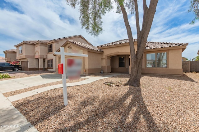 681 W Racine Loop, Casa Grande, AZ 85122 - mediterranean / spanish house featuring stucco siding, concrete driveway, and a tiled roof