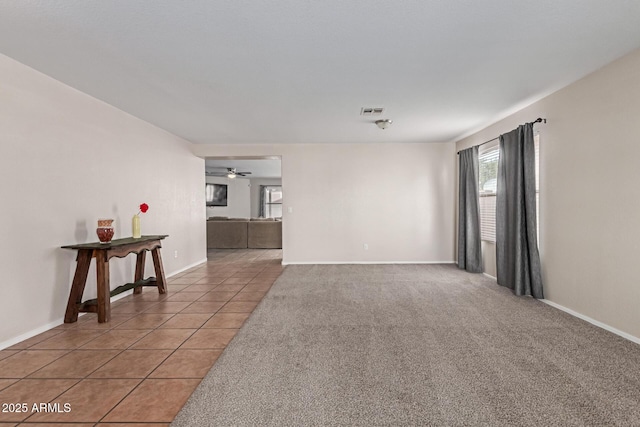 681 W Racine Loop, Casa Grande, AZ 85122 - unfurnished room featuring baseboards, light tile patterned floors, light carpet, and a ceiling fan