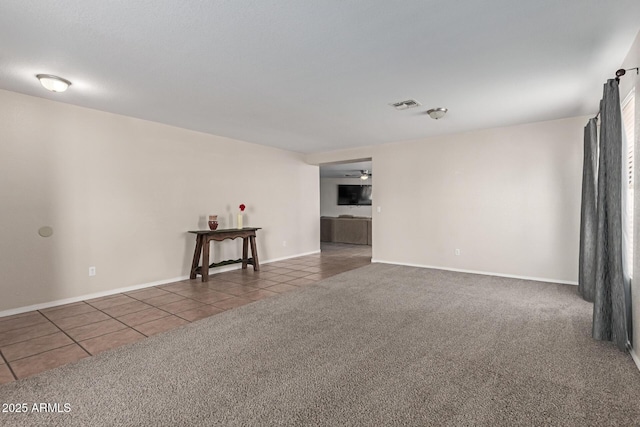 681 W Racine Loop, Casa Grande, AZ 85122 - unfurnished room featuring tile patterned floors, carpet, a ceiling fan, and baseboards