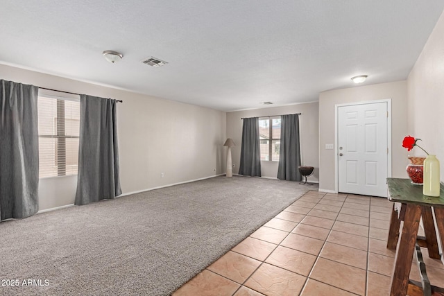 681 W Racine Loop, Casa Grande, AZ 85122 - foyer featuring light carpet, light tile patterned floors, and baseboards