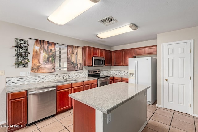 681 W Racine Loop, Casa Grande, AZ 85122 - kitchen with stainless steel appliances, a sink, light countertops, and light tile patterned floors