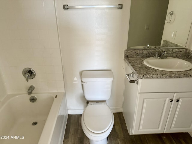 full bathroom with toilet, tiled shower / bath, and vanity