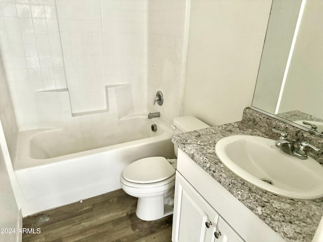 full bathroom with hardwood / wood-style flooring, tub / shower combination, toilet, and vanity