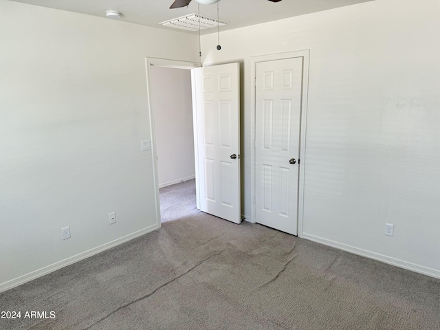 unfurnished bedroom with ceiling fan and carpet