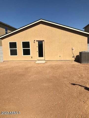 back of house with central air condition unit