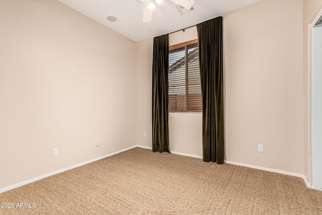 carpeted empty room with a ceiling fan, visible vents, and baseboards