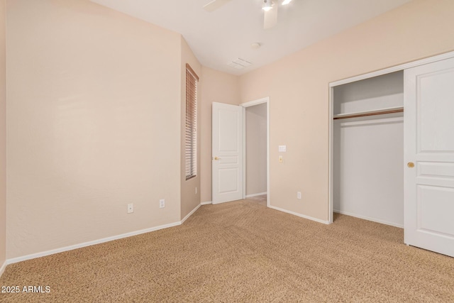 unfurnished bedroom featuring a closet, carpet flooring, a ceiling fan, and baseboards