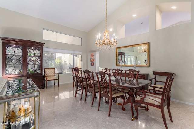 dining space featuring a chandelier and high vaulted ceiling