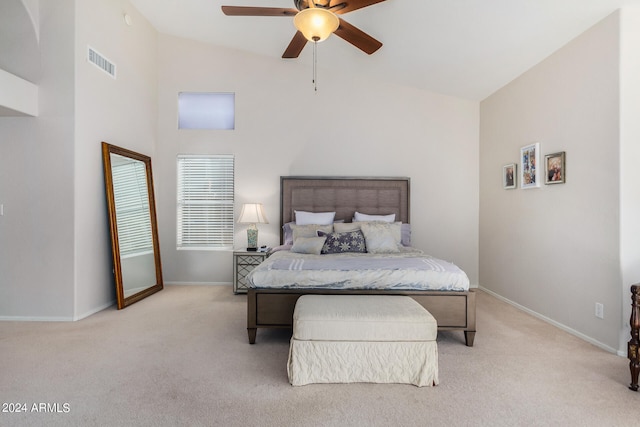 carpeted bedroom with high vaulted ceiling and ceiling fan