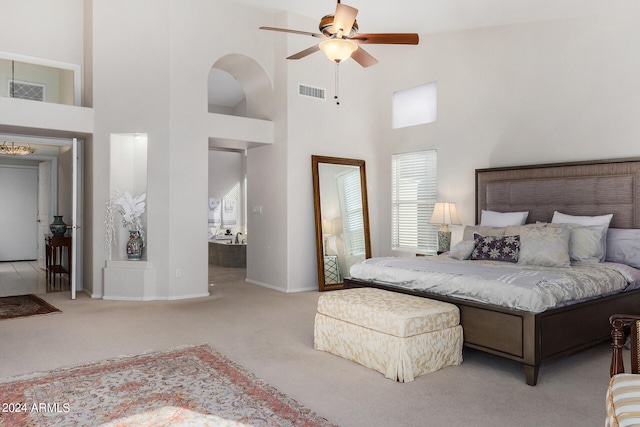 carpeted bedroom featuring a high ceiling and ceiling fan