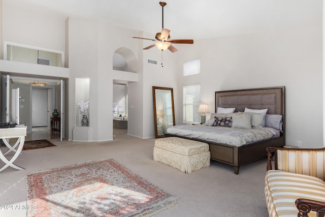 carpeted bedroom with a high ceiling and ceiling fan