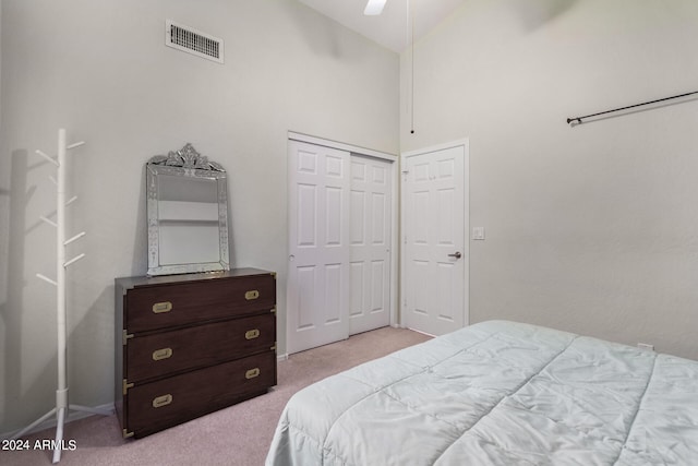 carpeted bedroom featuring high vaulted ceiling, ceiling fan, and a closet