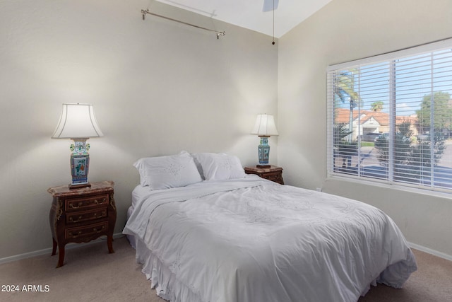 bedroom featuring vaulted ceiling, carpet flooring, and ceiling fan