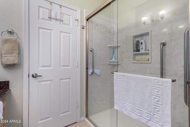 bathroom with a shower with door