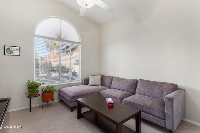 carpeted living room with ceiling fan and vaulted ceiling