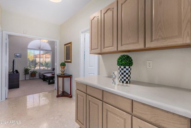 kitchen featuring light tile patterned floors and light brown cabinets