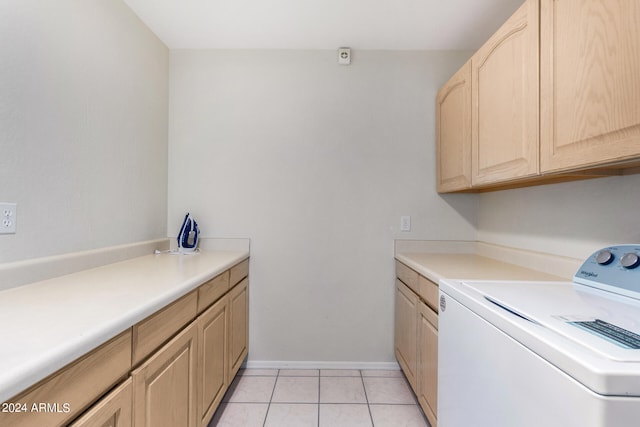 laundry area featuring washer / clothes dryer, cabinets, and light tile patterned floors