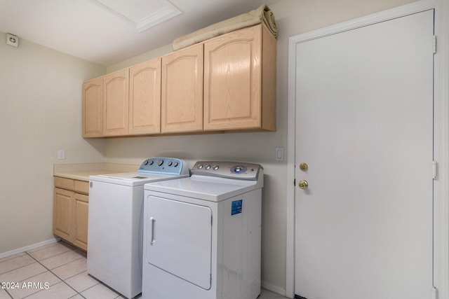 washroom with separate washer and dryer, cabinets, and light tile patterned flooring