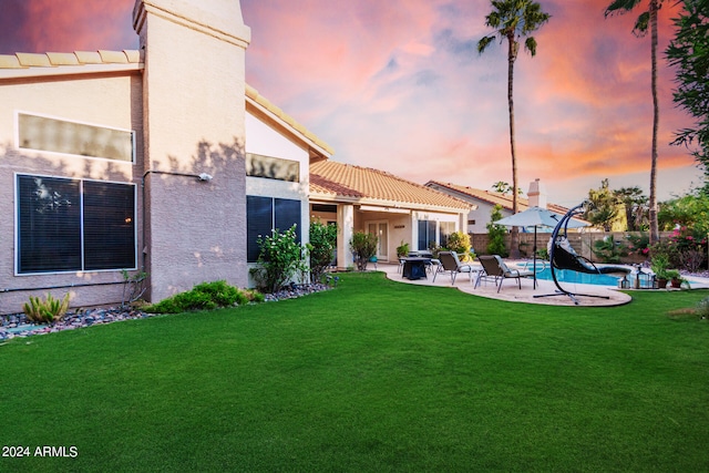 yard at dusk with a patio