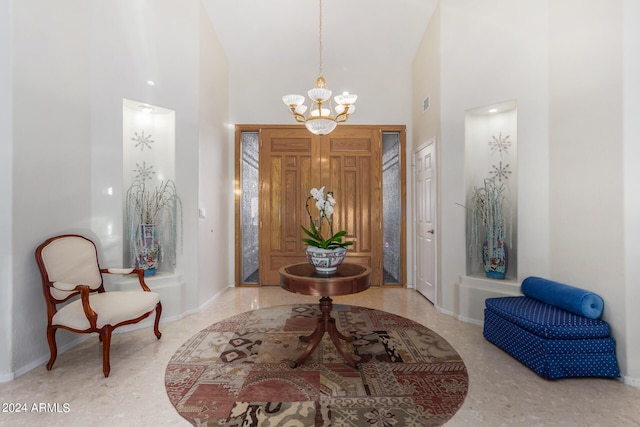 entrance foyer with a notable chandelier and high vaulted ceiling