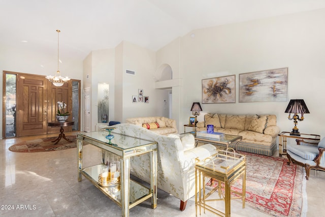 living room with high vaulted ceiling and a chandelier