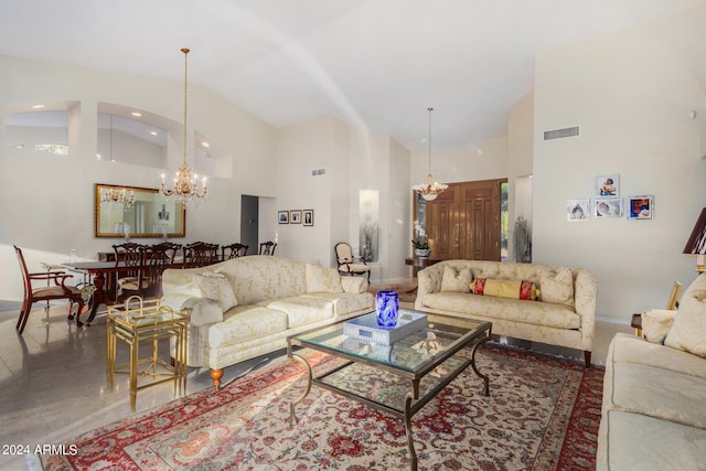 living room with an inviting chandelier and high vaulted ceiling